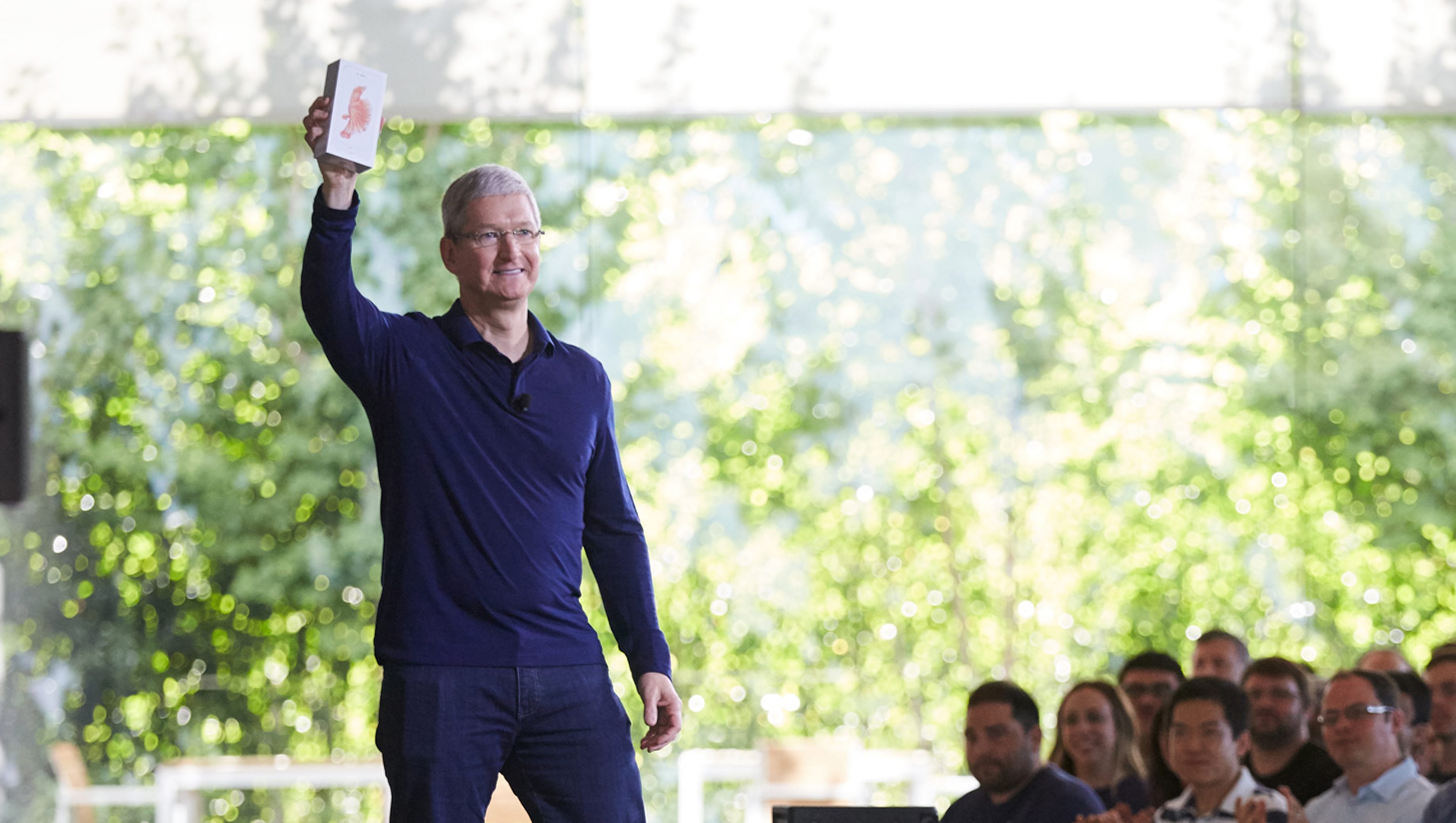 Apple CEO Tim Cook shows off the one billionth iPhone to Apple staff