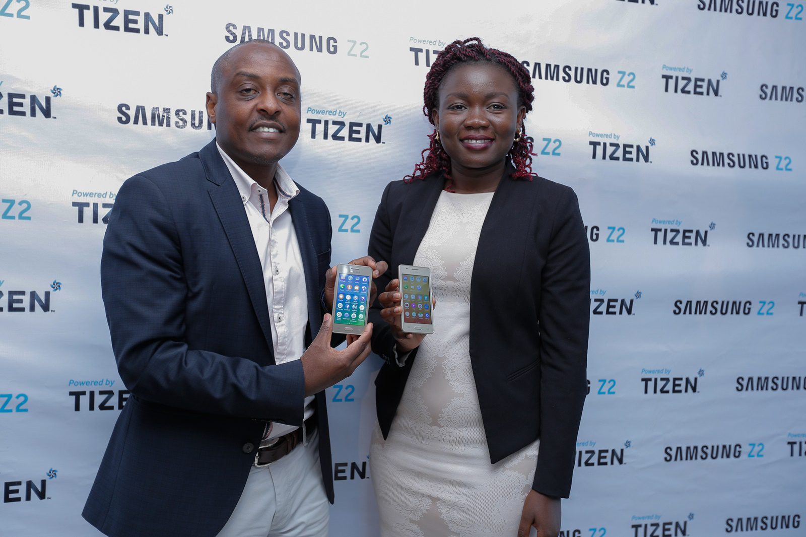 Samsung Electronics East Africa Mobile and IT Head Simon Kariithi and Product Manager Idda Rasanga pose with the device during the launch at Samsung's Nairobi offices