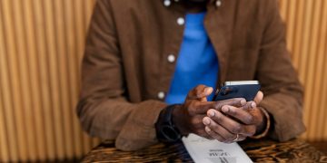 Man transacting on MPesa