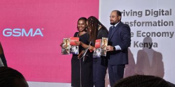 image of Dr. Margaret Nyambura Ndung’u, ICT CS and GSMA leaders holding the GSMA report at movenpick hotel