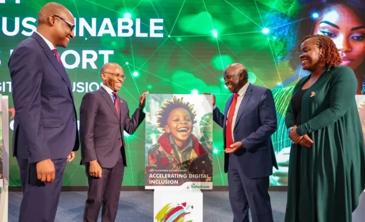 Safaricom CEO Peter Ndegwa standing next to a dummy of the 2024 Safaricom Sustainability Report