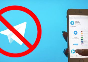 Image showing suspension of Telegram services in Kenya. Lady holding phone with Telegram app.