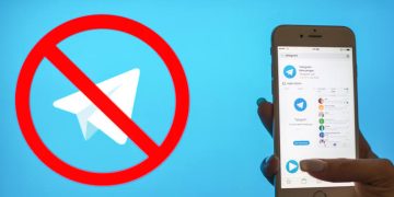 Image showing suspension of Telegram services in Kenya. Lady holding phone with Telegram app.