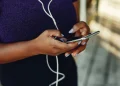 Woman typing on phone
